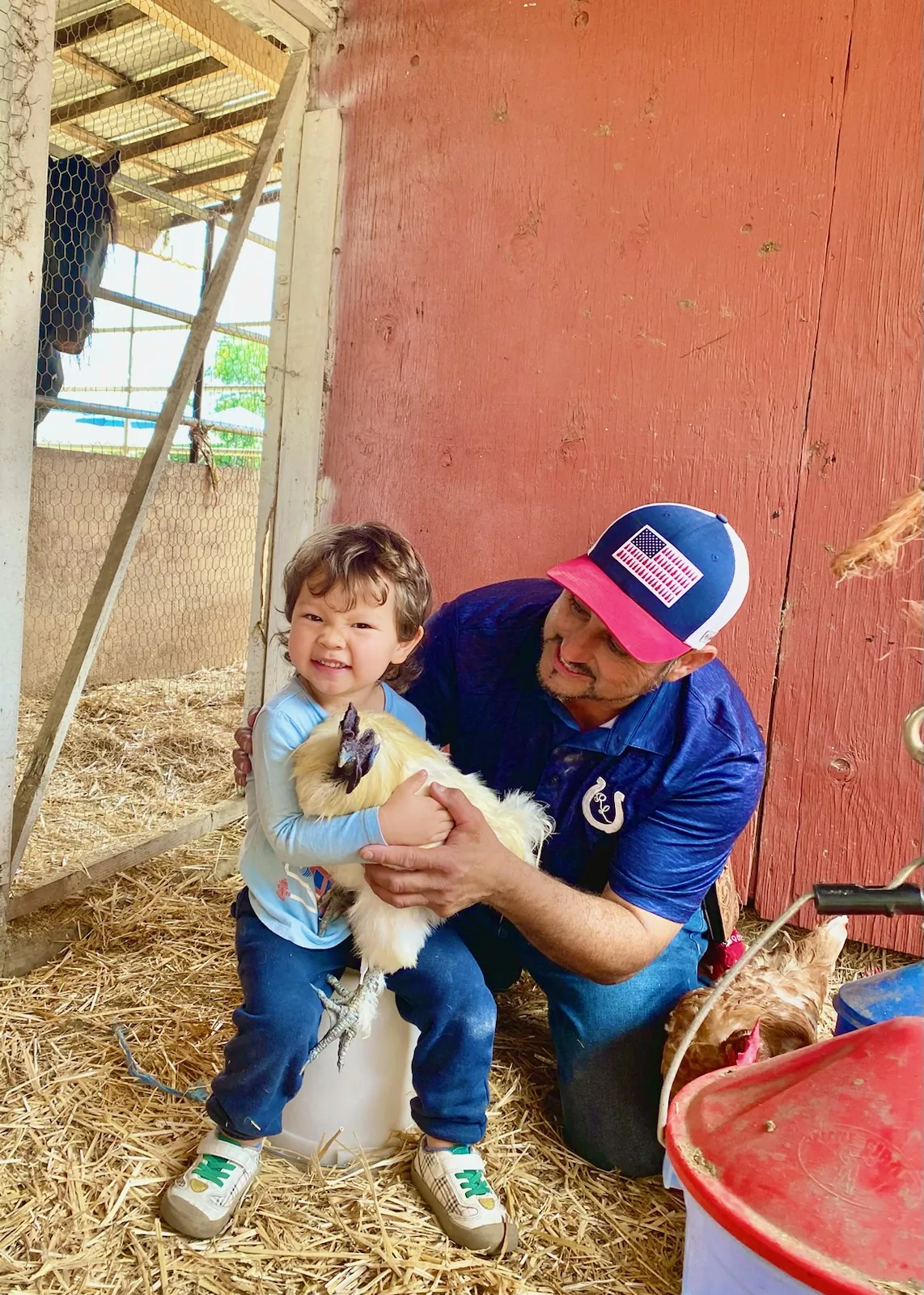 A young guest with a lamb — Rancho Lagunas outdoor ranch event venue in Bloomington, California