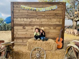 Rustic photo backdrop with hay bales — Rancho Lagunas outdoor ranch event venue in Bloomington, California