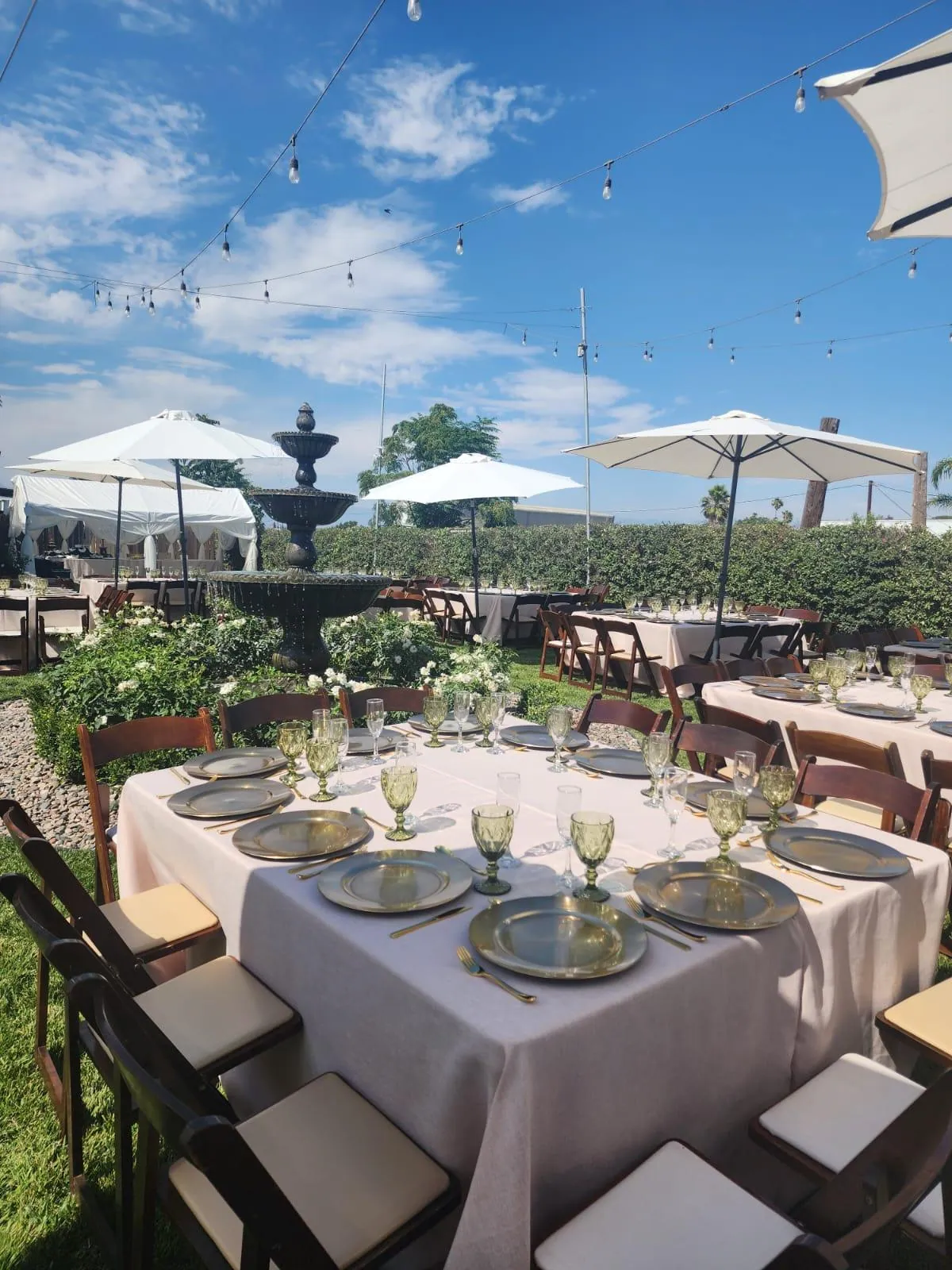 Tables set beside the fountain — Rancho Lagunas outdoor ranch event venue in Bloomington, California